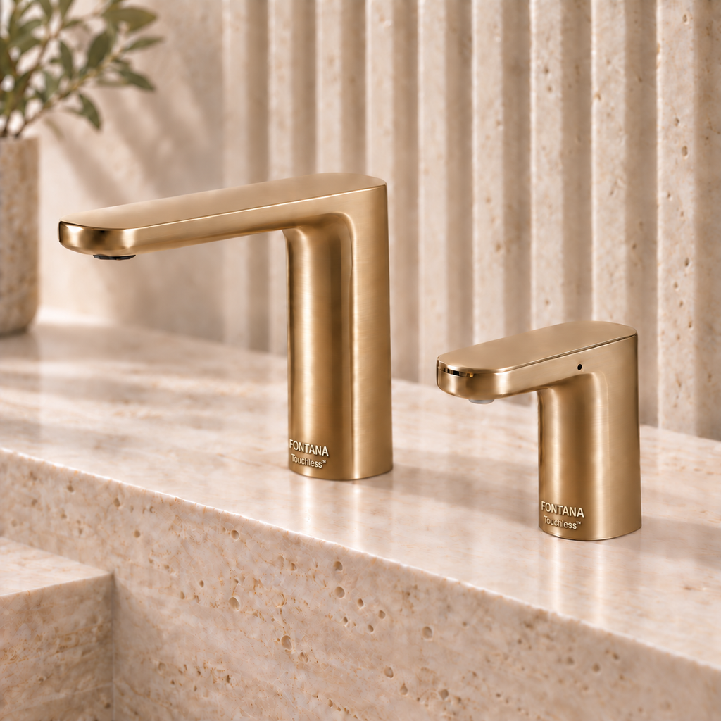 Coordinated commercial touchless faucet and soap dispenser in a warm brushed metal finish